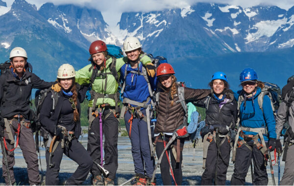 Traveler group photo all with rock climbing helmets and gear on