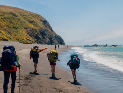 People backpacking along the Lost Coast of California.