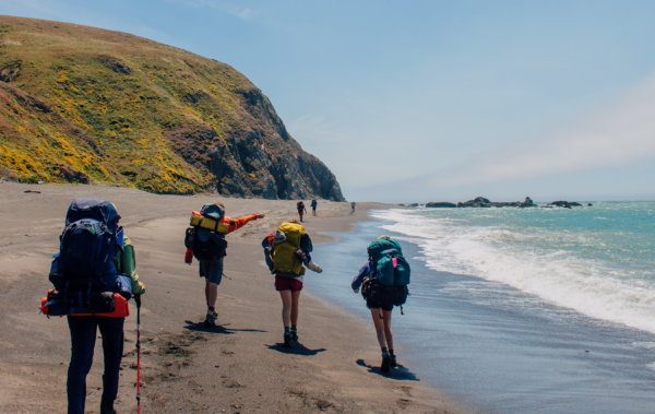 People backpacking along the Lost Coast of California.