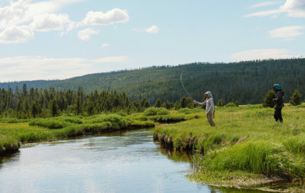 students fly fishing in remote river in Wyoming