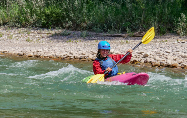 smiles while whitewater kayaking on the snake river