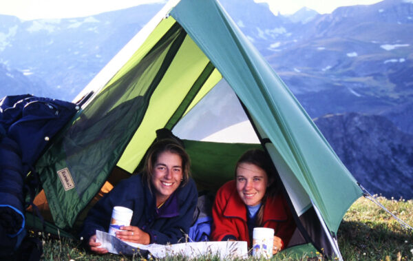 Two girls smiling in their tent