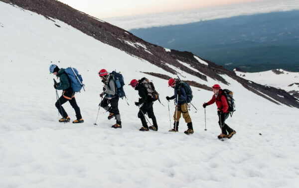 Travelers hiking up Mount Shasta in the snow