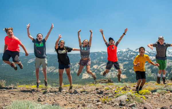 Group of travelers jumping in the air