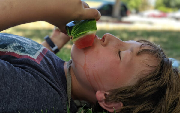 Traveler eating a watermelon