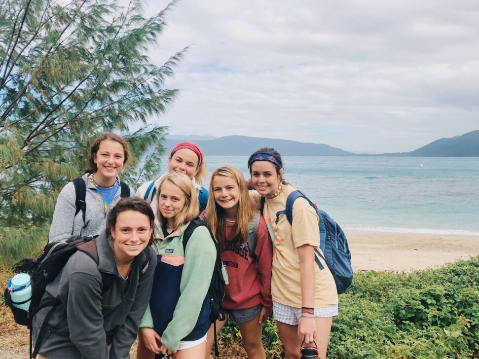 Group of girls smiling by the ocean in Australia.