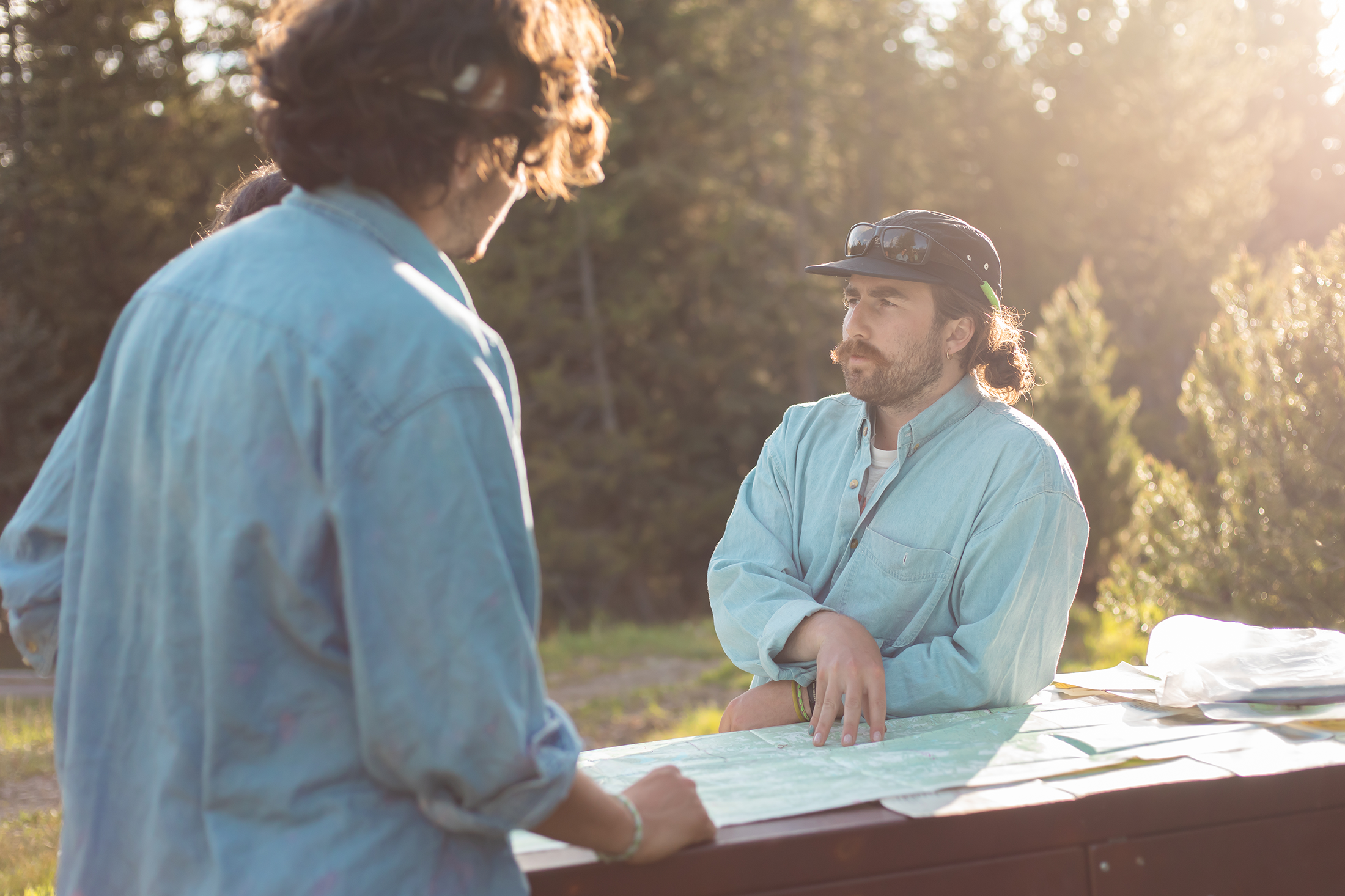 Person holding a map explaining details and teaching someone. 